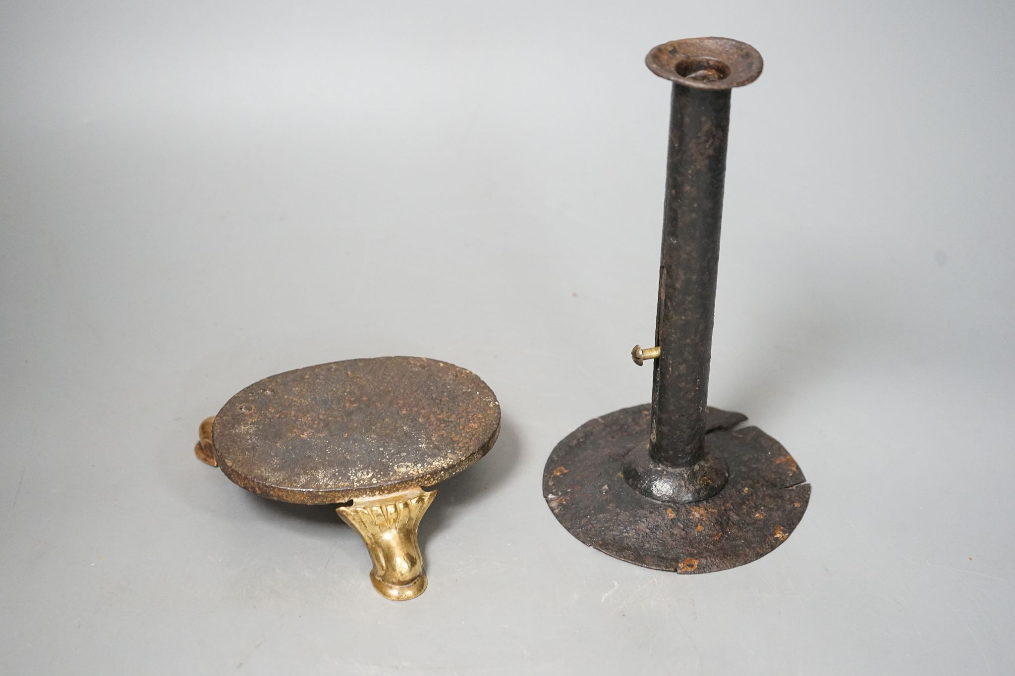 An 18th century provincial tole candlestick and an 18th century iron and brass oval stand, candlestick 20cm